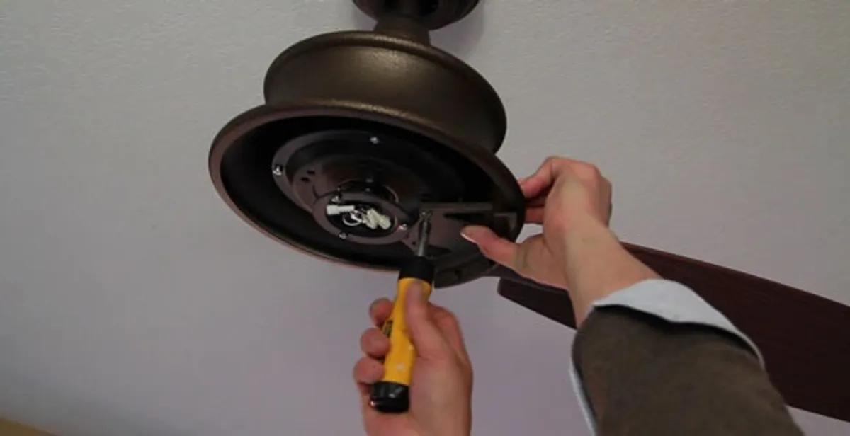 Electrician installing ceiling fan mounting bracket and fixture in Charleston, SC