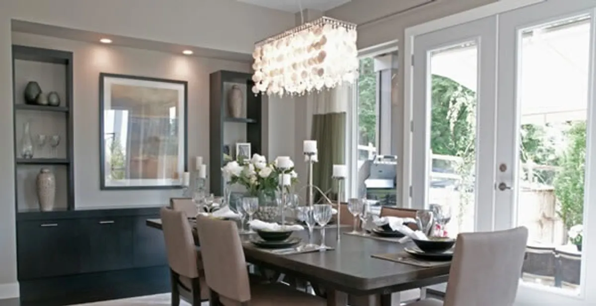 Elegant dining room chandelier installation above table in Charleston, SC